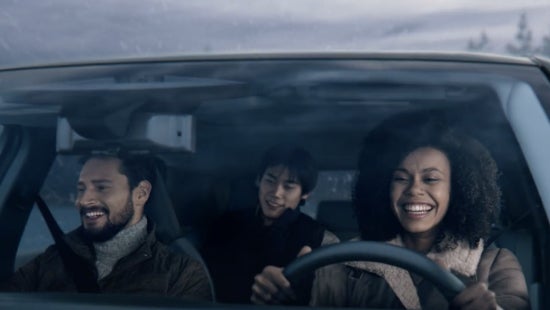 Three passengers riding in a vehicle and smiling | Friendship Nissan of Boone in Boone NC
