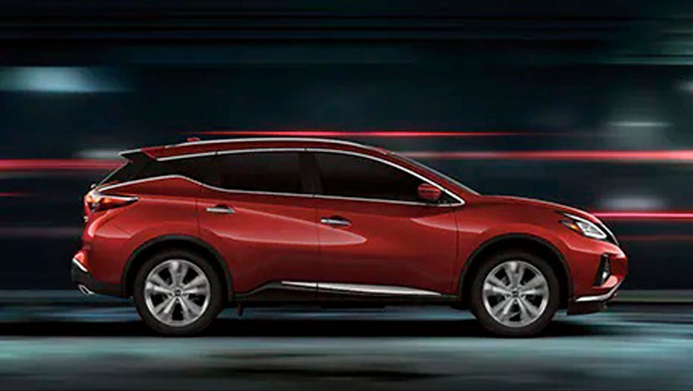 2023 Nissan Murano shown in profile driving down a street at night illustrating performance. | Friendship Nissan of Boone in Boone NC